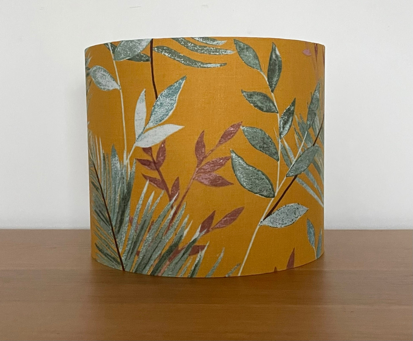 Mustard-yellow-lampsahde-with-tropical-leaves-drum-light-shade