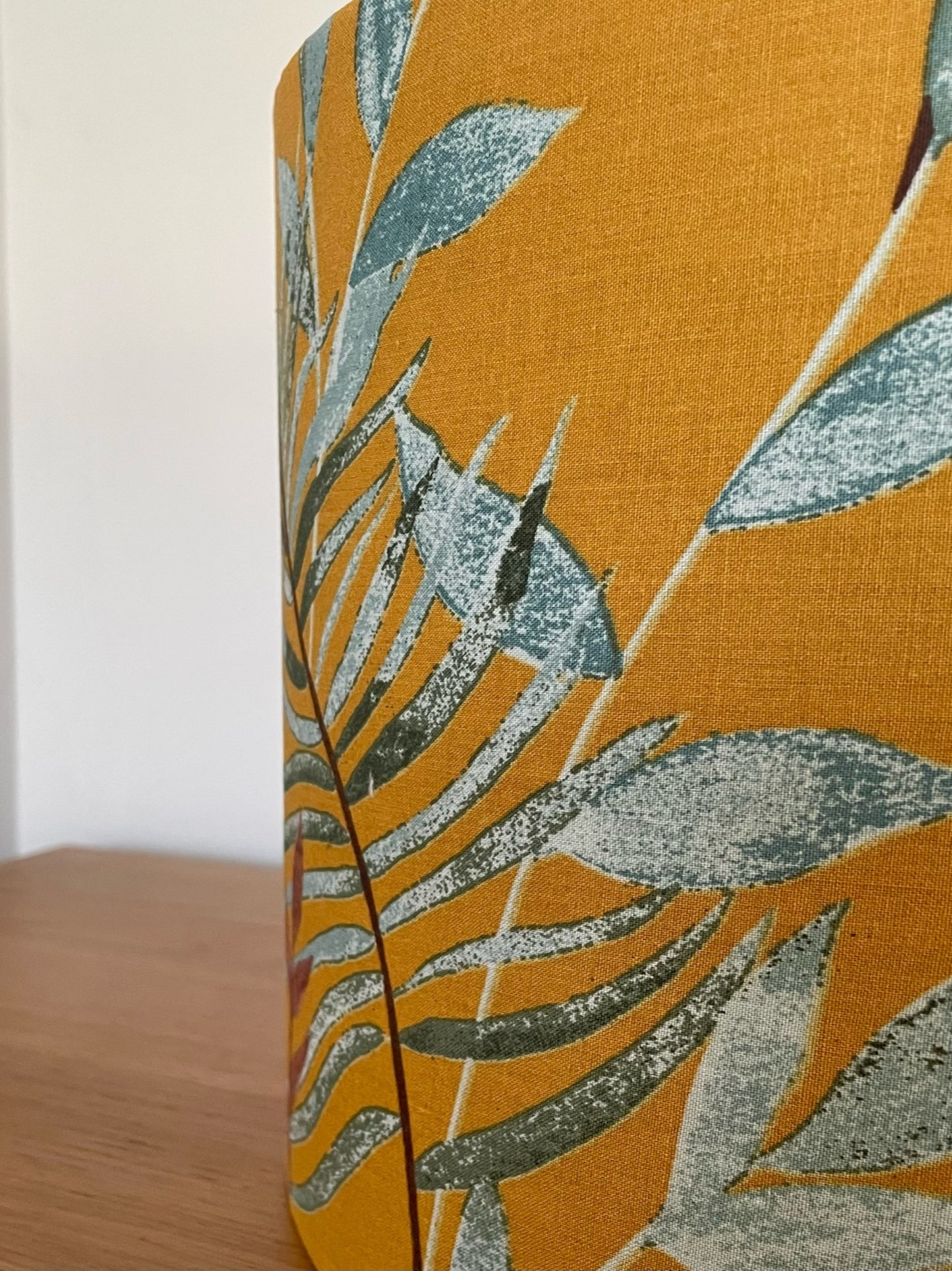 Mustard-yellow-lampsahde-with-tropical-leaves-table-light-shade