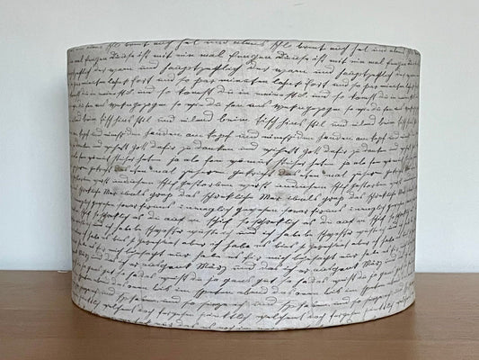 Tim Holtz Eclectic Elements charcoal fabric lampshade. Vintage handwriting on a distressed cream background. With a choice of white or metallic lining.