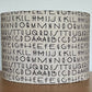 Tim Holtz Eclectic Elements charcoal fabric lampshade. Typography on a distressed cream background. With a choice of white or metallic lining.