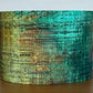 Cylindrical container with vintage-style text design on a wooden surface