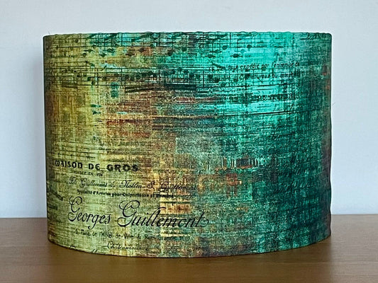 Cylindrical container with vintage-style text design on a wooden surface