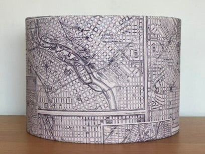 Lampshade with a map design on a wooden surface