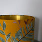Mustard-yellow-lampsahde-with-tropical-leaves-botanical-boho