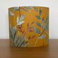    Mustard-yellow-lampsahde-with-tropical-leaves-drum-light-shade