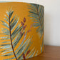    Mustard-yellow-lampsahde-with-tropical-leaves-drum-pendant